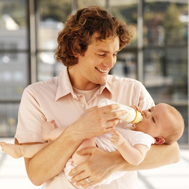 father bottle feeding baby (6-12 months)