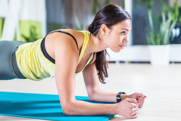 portrait fitness training athletic sporty woman doing plank exercise in