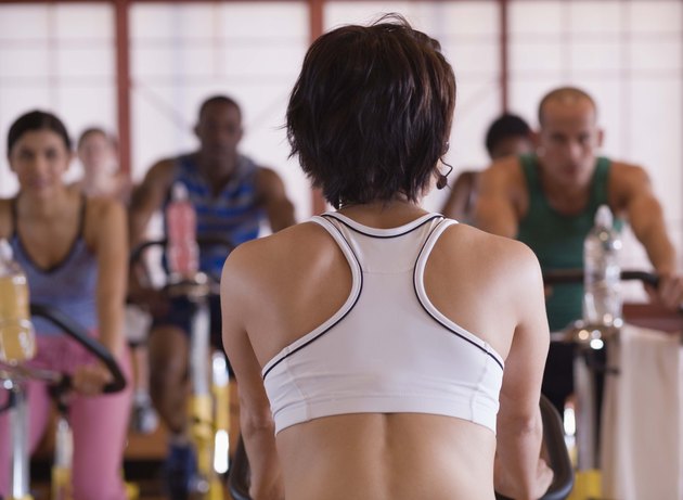 Rear view of instructor in spinning class