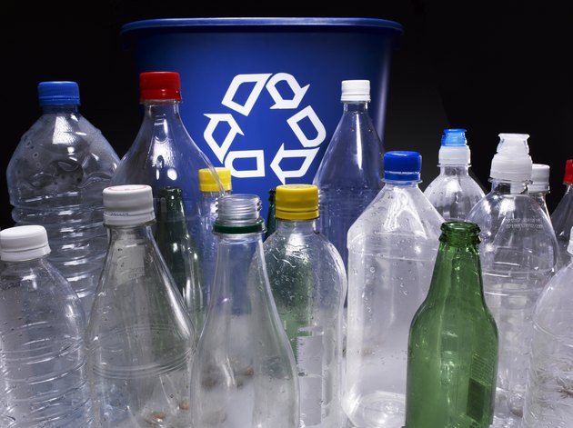 Assorted bottles and trash bin with recycle sign