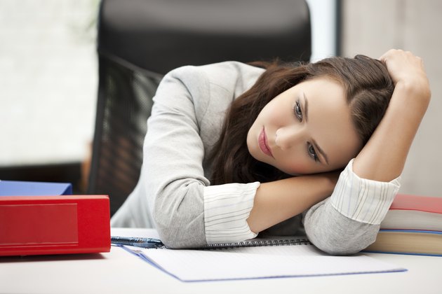 bored and tired woman behid the table