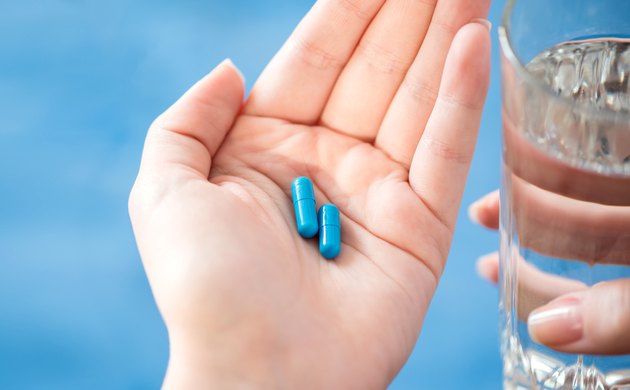 Female hand holding a medicine.