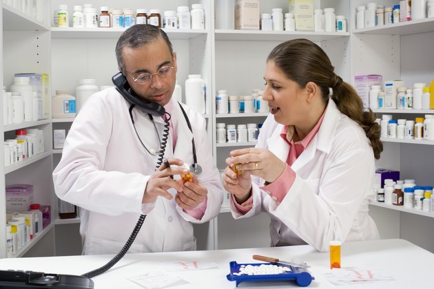 Pharmacists on the phone holding medication