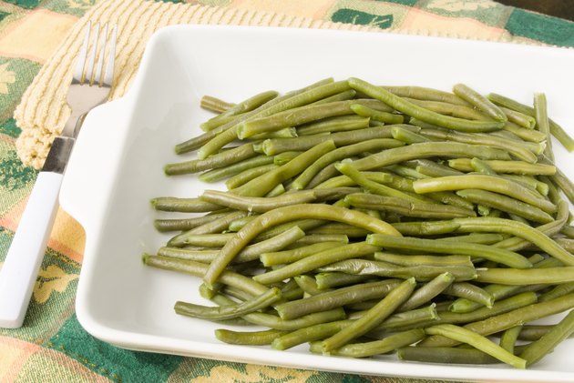 beans in casserole dish with Thanksgiving tablecloth