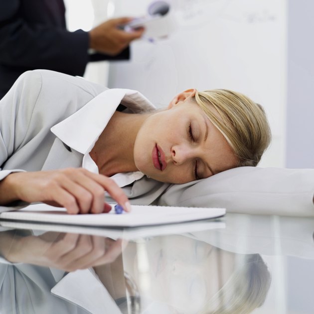 businesswoman resting her head down on the table