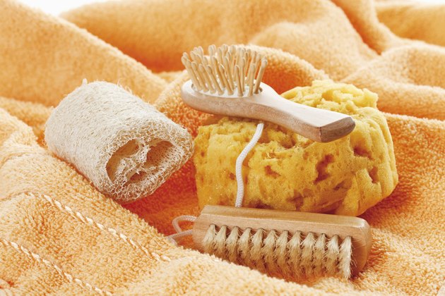Variety of sponges and brushes on towel