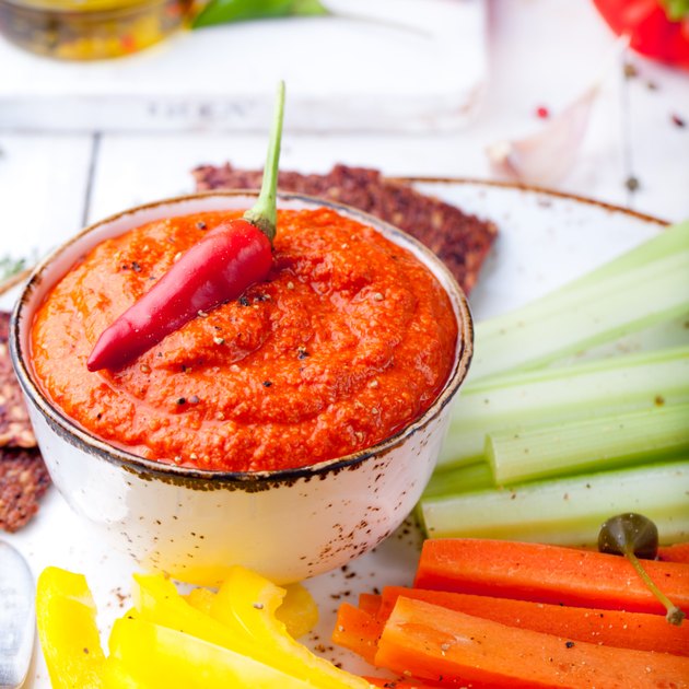 Roasted pepper dip, sauce, spread with fresh carrot, celery sticks