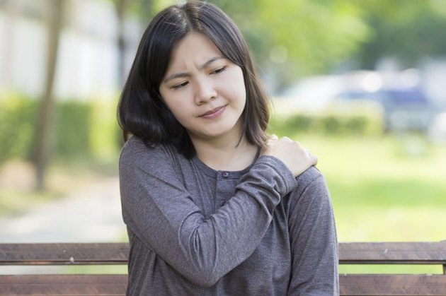 Woman: Shoulder Pain at Park