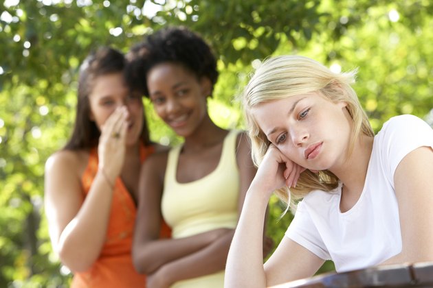 Teenage girls whispering gossip
