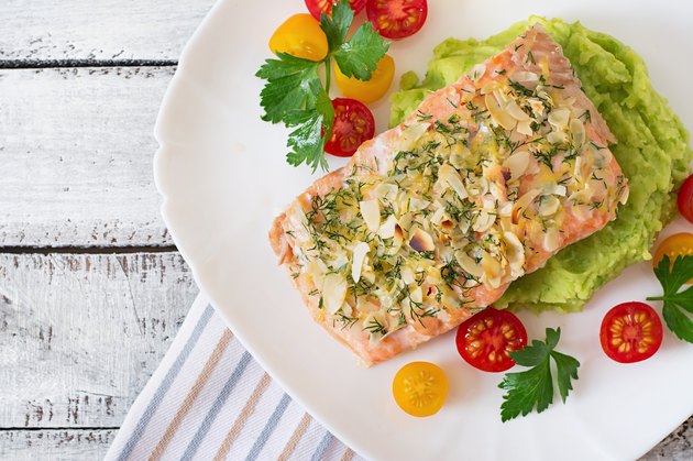 Baked salmon with cheese and almond crust and garnished