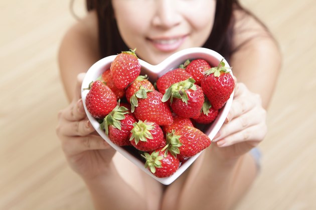 Woman smiling with strawberry