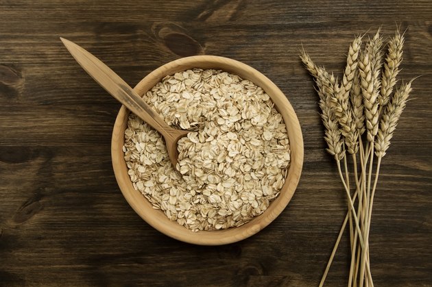 oatmeal flakes in a wooden bowl with a spoon