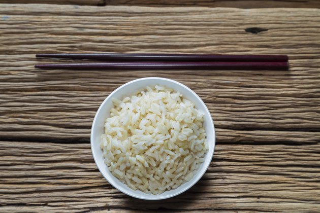 Bowl of brown rice with chopsticks