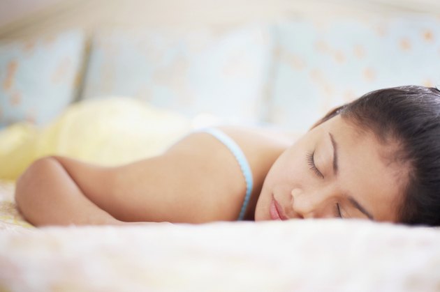 Young woman asleep in bed