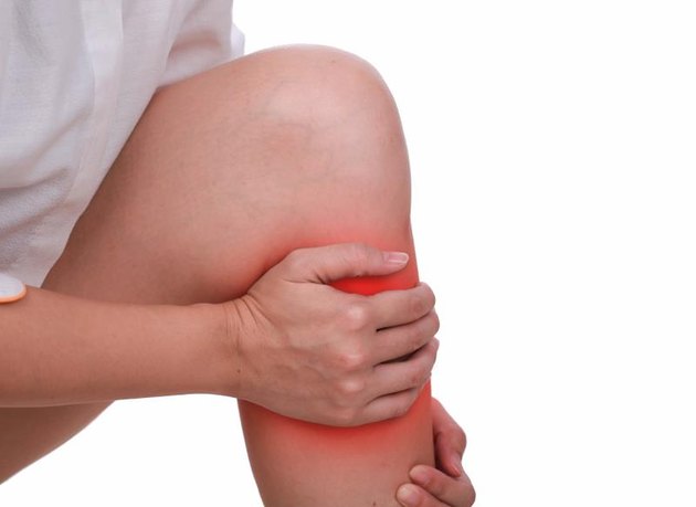 Close up suffering male pain in shin isolated white background.