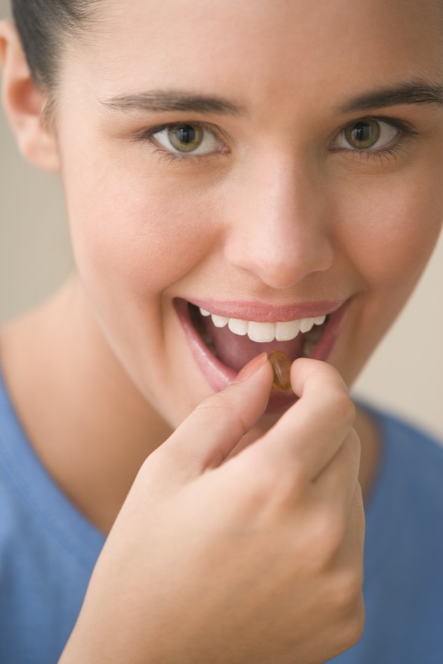 Teenage girl taking vitamin