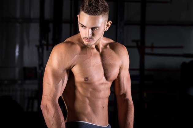Handsome muscular young man in gym