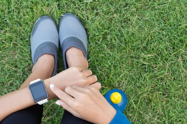 athletic woman using smartwatch on top view
