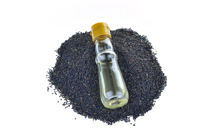 Black sesame seeds on a white background