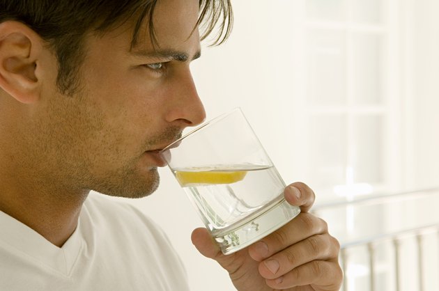 Man drinking water with lemon
