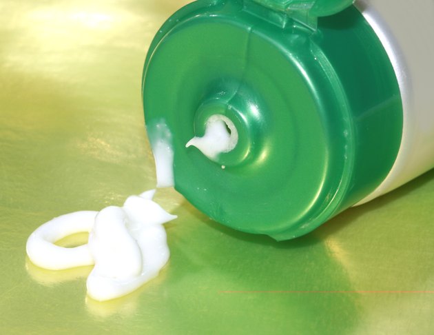 green shampoo bottle on yellow background