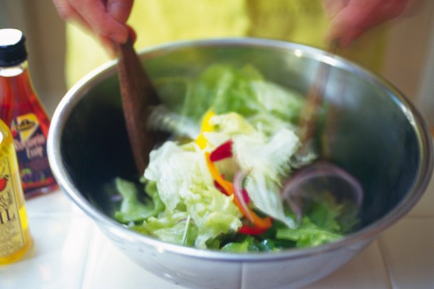 Kitchen worker mixing mixed salad, Blurred Motion