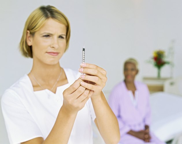 close-up of a female nurse holding a syringe