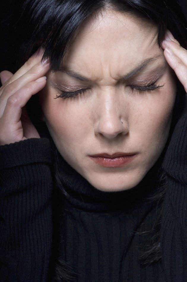 Close up of woman rubbing temples