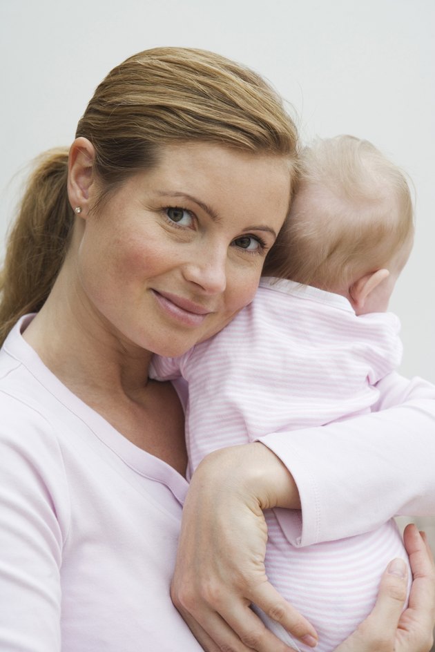Portrait of a mid adult woman holding her daughter