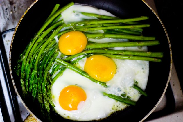 Eggs and asparagus in skillet