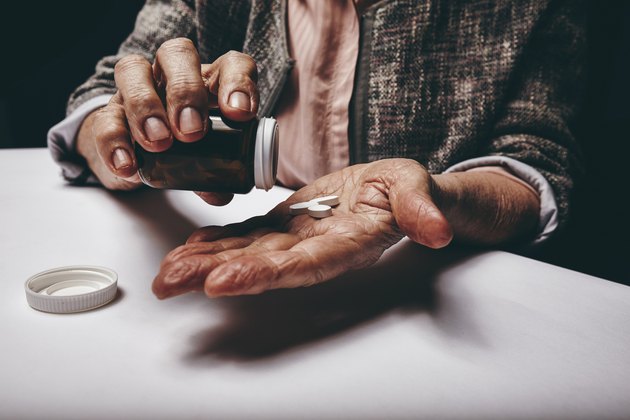 Senior woman taking medicine.