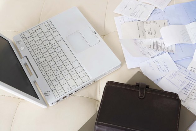 Bills and receipts by laptop