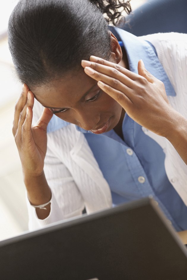High angle view of a businesswoman suffering from a headache