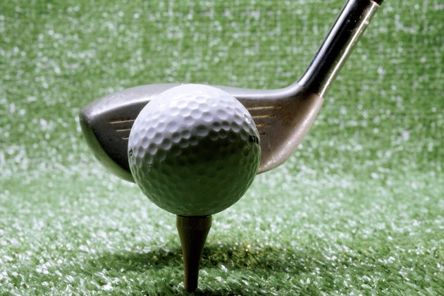 Close-up of a golf club next to a golf ball