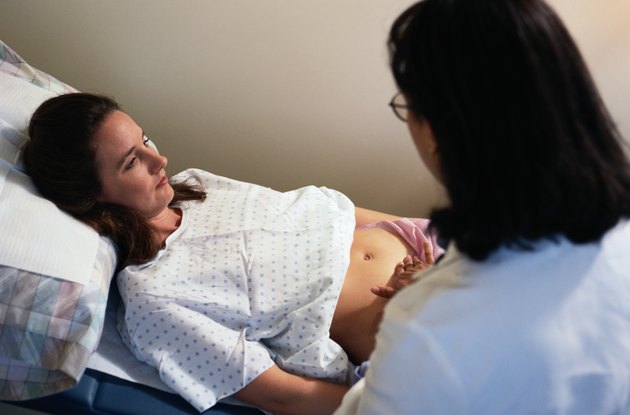Doctor Checking Position of Pregnant Woman's Baby