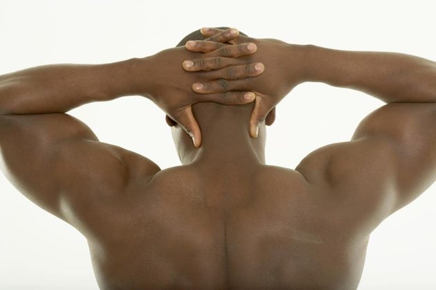 Young man hands behind head, rear view, close-up