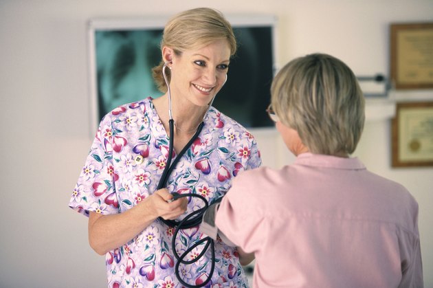 Female nurse examining a female patient