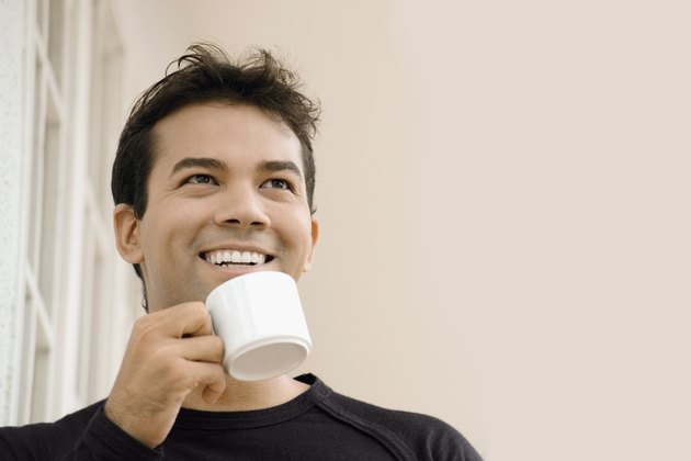 Close-up of a businessman holding a cup of tea