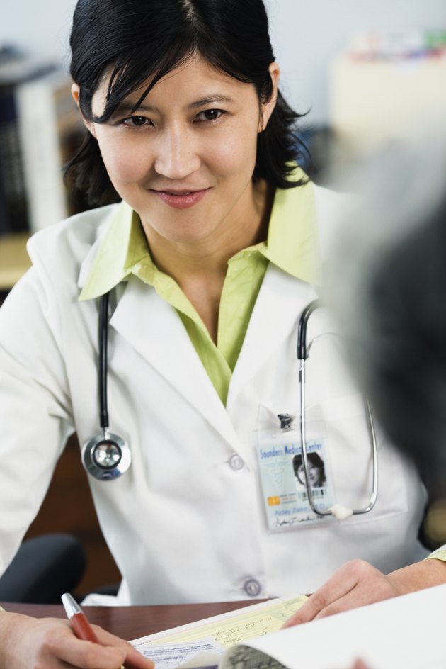 Kazakh female doctor listening to patient