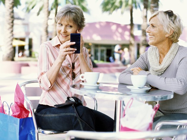 Close-up of two mature women sitting at a table