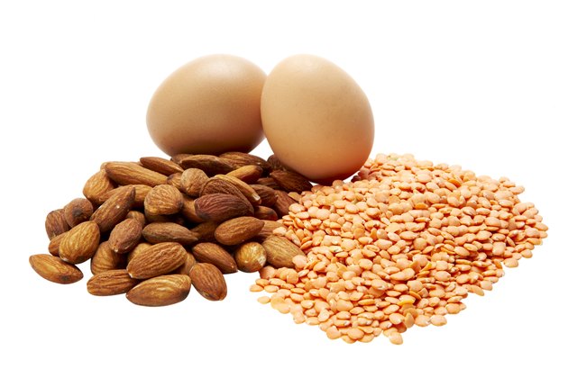 Eggs, almonds, and lentils on white background