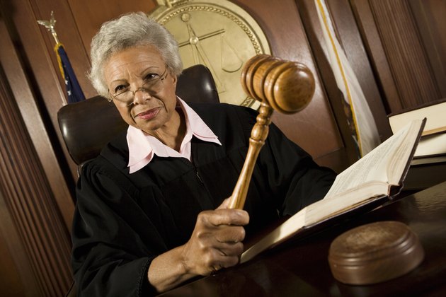 Female judge holding hammer in court