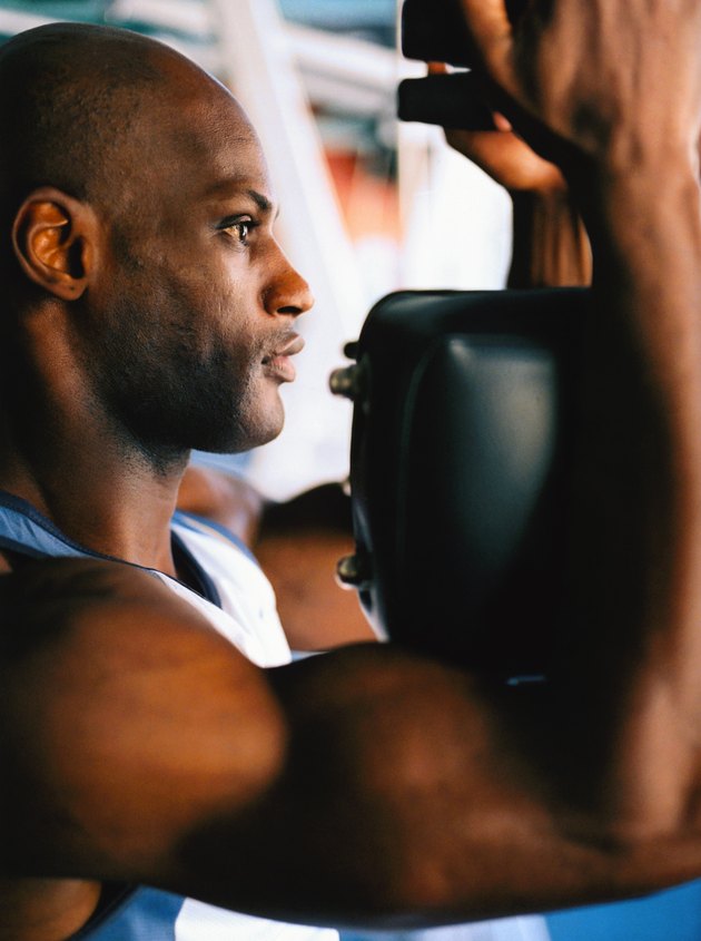 side profile close-up of a man exercising in a gym