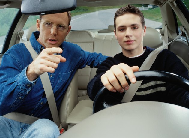 Man Teaching a Boy How to Drive