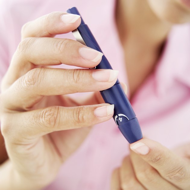 close-up of a woman removing blood from her finger for a blood test