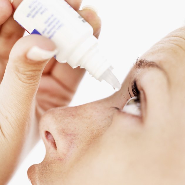 close-up of a woman using eye drops