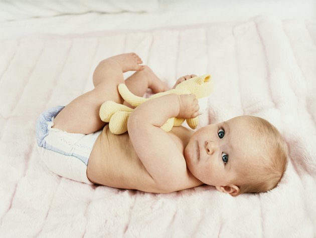 Portrait of a Baby Lying on a Bed