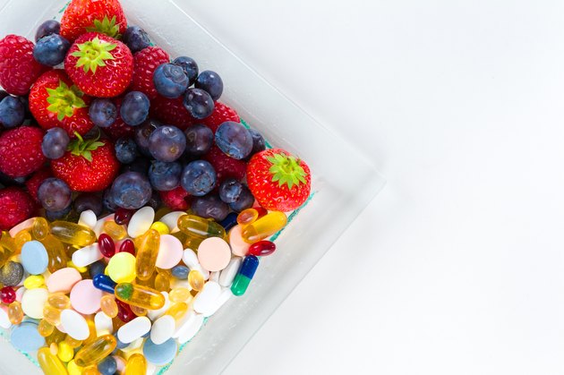 Healthy lifestyle, Fruit and pills, vitamin supplements with copy space