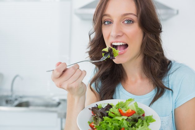 Brunette eating healthy salad