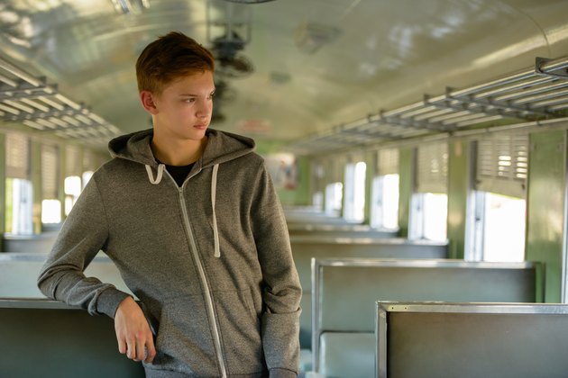Teenager boy traveling with train